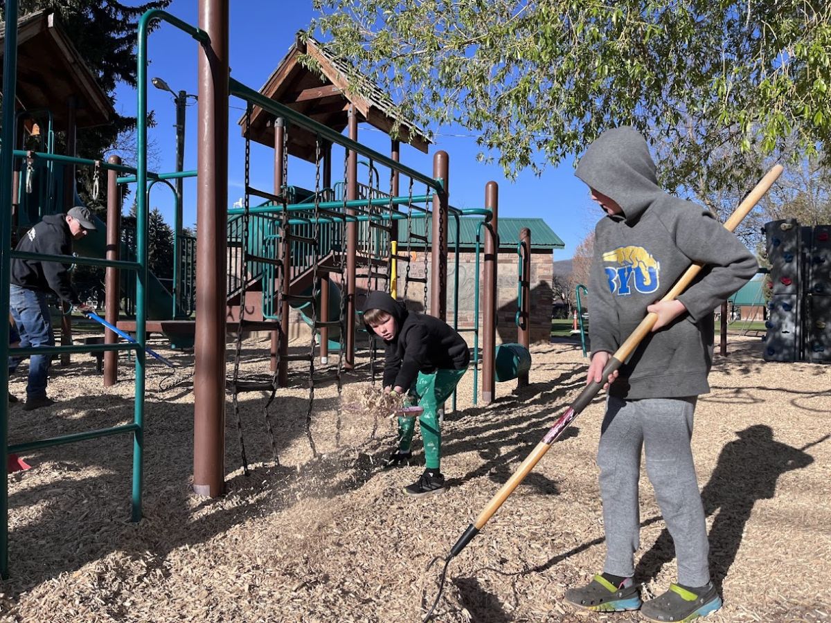 kids shoveling bark at a playground